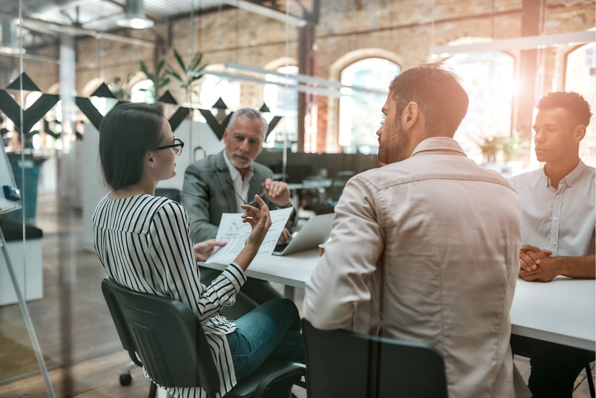 team members discussing business strategy around a table